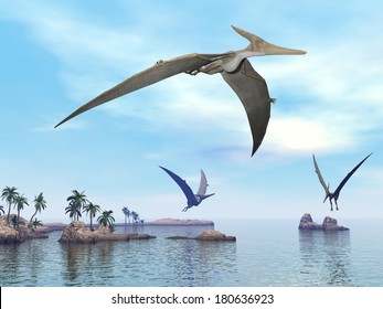 Three pteranodon dinosaurs flying upon landscape with hills, palm trees and water in cloudy sunset sky