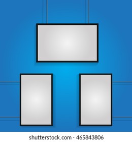 Three white poster with black frame on  blue wall 