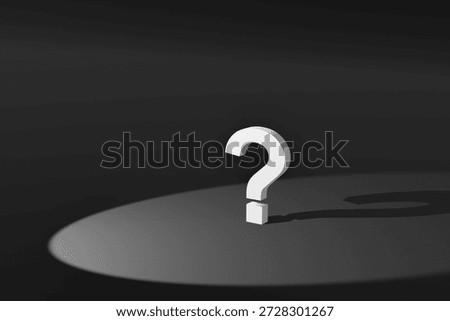 A three-dimensional question mark in the spotlight