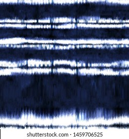 tie dyed fabric of indigo color on white cotton. Hand painted fabrics. Shibori dyeing with abstract folk striped motif  textured background. Seamless Pattern.