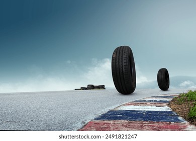 tires positioned on a road with a blue sky and distant mountains in the background. Ideal for automotive and tire-related themes. - Powered by Shutterstock