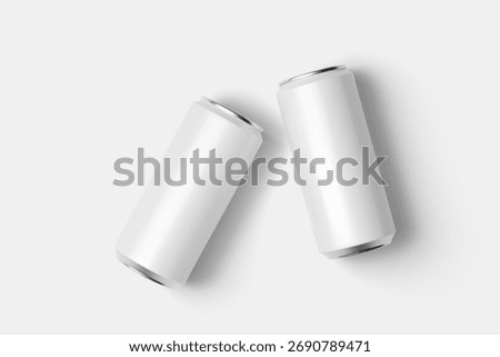 Top down view captures two modern beverage cans angled on a clean, bright surface, casting soft shadows for product presentation