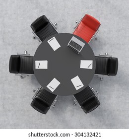 Top View Of A Conference Room. A Black Round Table, Six Chairs, One Of Them Is Red. A Laptop And Five Papers. Office Interior. 3D Rendering.