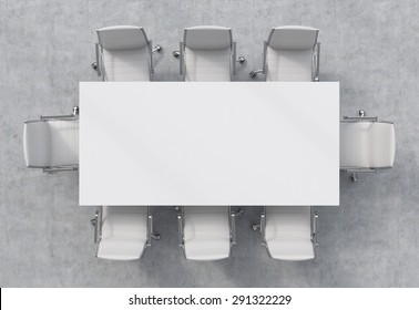 Top view of a conference room. A white rectangular table and eight chairs around. 3D interior.