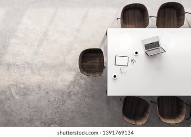 Top View Of Desktop With Laptop, Coffee Cup And Chairs In Modern Meeting Room Interior. 3D Rendering 