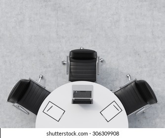 Top View Of A Half Of The Conference Room. A White Round Table, Three Black Leather Chairs. A Laptop With Legal Pads Are On The Table. Office Interior. 3D Rendering.