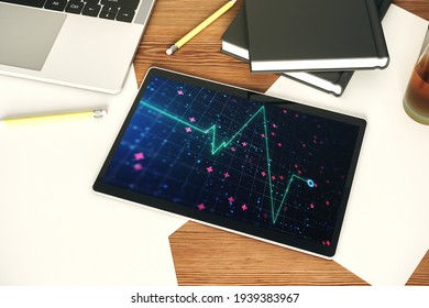 Top view of modern digital tablet monitor with creative abstract heart rate hologram. Healthcare technolody concept. 3D Rendering