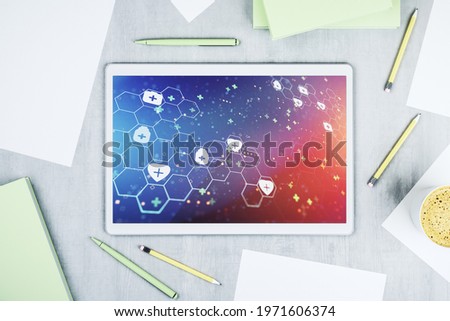 Top view of modern digital tablet monitor with creative abstract medical hologram. Healthcare technolody concept. 3D Rendering