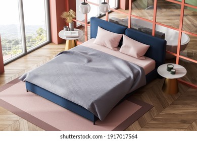 Top View Of Wooden Living Room With Blue Bed And Pink Linens, Bathtub On Parquet Floor. Bedroom In Modern Open Space Studio With Window 3D Rendering, No People