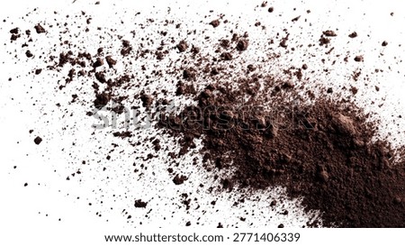 A top-down shot of scattered soil, revealing a collection of dark earth particles against a clean, white background. Ideal for agricultural or environmental themes.