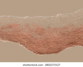 Torn brown paper texture with an irregular edge against a similar-colored background. The surface features a reddish-brown metallic sheen, suggesting a rough, fibrous texture. The tear pattern creates a natural, uneven line, highlighting the contrast between the matte brown and the coppery shimmer. The overall appearance is rustic yet elegant, useful for design applications requiring a natural or vintage aesthetic.
