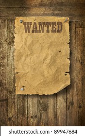 Torn Wild West Wanted Poster On Old Wooden Wall
