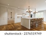 Traditional white kitchen with long island and wooden chairs with varnished wood flooring. Classic kitchen with large chandeliers and kitchen appliances. 3d rendering. 3D Illustration