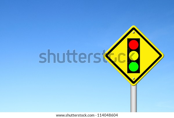 Traffic light ahead warning sign with blue sky\
background blank for\
text