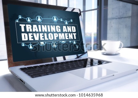 Training and Development text on modern laptop screen in office environment. 3D render illustration business text concept.