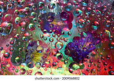 Transparent raindrops falling down against the turquoise-red background with silhouettes of yellow-blue  flowers. Abstract fantasy. 3D render.