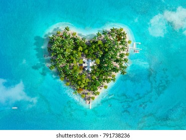 Tropical island in the shape of heart. Aerial view. 3D illustration