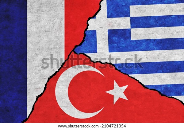 Turkey, France and Greece\
painted flags on a wall with a crack. Turkey, Greece and France\
conflict