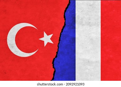 Turkey and France painted flags on a wall with a crack. France and Turkey conflict. France and Turkey flags together. Turkey vs France