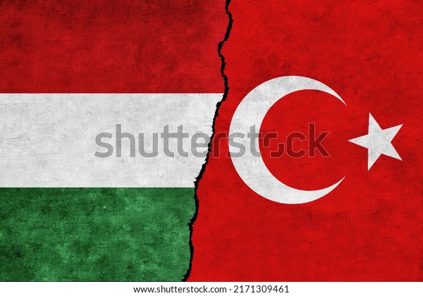 Turkey\
and Hungary painted flags on a wall with a crack. Hungary and\
Turkey relations.Turkey and Hungary flags\
together