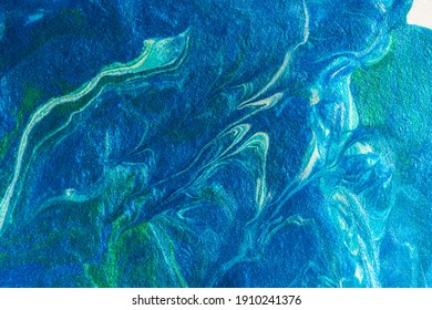Turquoise blue abstract background in the technique of fluid art. liquid art pattern. Original art. Simulation of the depth of the ocean and the sea surface. Modern design. Drawing with acrylic paints