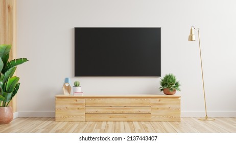 TV On The Cabinet In Modern Living Room With Plant On White Wall Background.3d Rendering