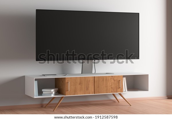 TV wide screen on the TV stand\
in modern living room with white wall. Side view. 3d\
illustration