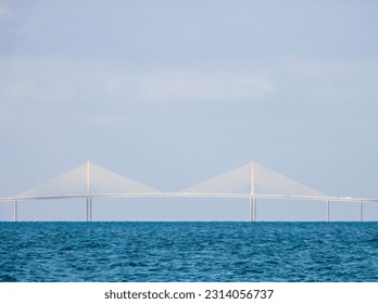 Twin towers of the cable-stayed main span of Bob Graham Sunshine Skyway Bridge, a four-lane toll road across Lower Tampa Bay, in west central Florida. Digital oil-painting effect, 3D rendering.