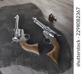 Two 1873 revolvers on camo net