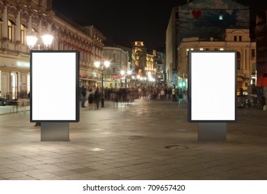 Two Blank Street Billboards At Night. Isolated With Clipping Path Around Advertising Display. 3d Illustration.