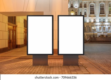 Two Blank Street Billboards At Night. Isolated With Clipping Path Around Advertising Display. 3d Illustration.