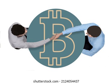 Two Businessmen Making A Peer To Peer Bitcoin Deal Shake Hands Over A Table Decorated With A Bitcoin Logo In A 3-d Illustration.