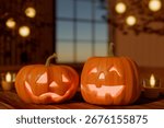 Two carved jack-o-lantern pumpkins glowing on a table during halloween evening indoors. 3d rendering