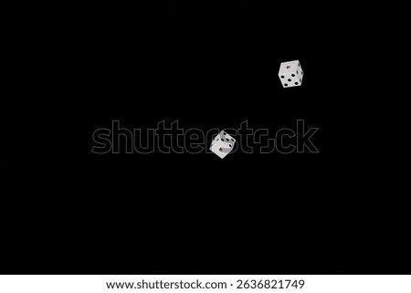 Two dice falling on a black background