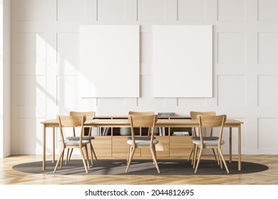 Two Empty Canvases On The White Living Room Wall With Panels. Interior With A Table, Chairs, An Oval Rug On The Parquet Floor And A Sideboard. A Concept Of Modern Home And Office Design. 3d Rendering