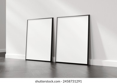 Two empty picture frames resting on a wooden floor against a white wall, suitable for art display or mockup design, 3d render.