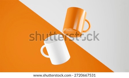 Two floating mugs on a diagonal Tangerine and White background, one White mug and one Tangerine mug.