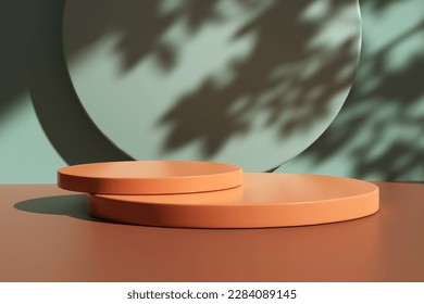 Two glossy orange colored round podiums on table counter with leaf shadows on the light green wall. Background for luxury beauty, cosmetic, product or food display backdrop. 3D render.