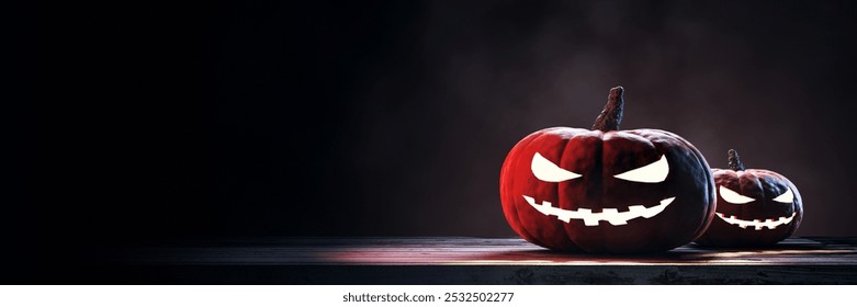 Two glowing Halloween pumpkins with scary faces on a wooden surface, dark background. Concept of Halloween festivity and decoration. 3D Rendering. - Powered by Shutterstock