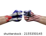 Two hands punch to each others on white background. Country flags painted fists, conflict crisis concept between cuba and usa
