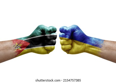 Two Hands Punch To Each Others On White Background. Country Flags Painted Fists, Conflict Crisis Concept Between Mozambique And Ukraine