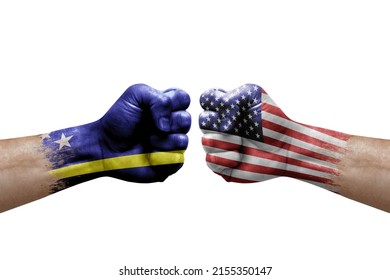 Two hands punch to each others on white background. Country flags painted fists, conflict crisis concept between curacao and usa