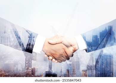 Two hands shaking overlay in front of a city skyline with cranes. Business handshake of partnership and agreement. Hands shaking, teamwork, business agreement, and cooperation.