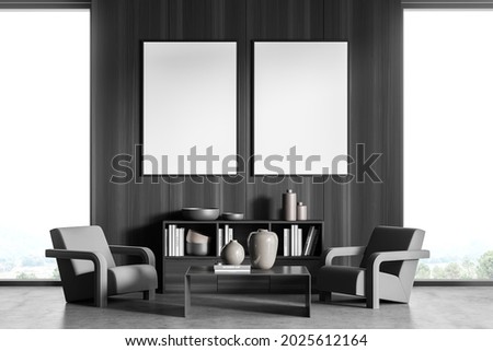 Two mockup posters in the seating area of modern house interior with minimalist concept. Dark grey design, using wood wall cover, symmetric balance of furniture and on trend coffee table. 3d rendering