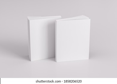Two softcover or paperback vertical white mockup books standing on the white table. Blank front and back cover. 3d illustration