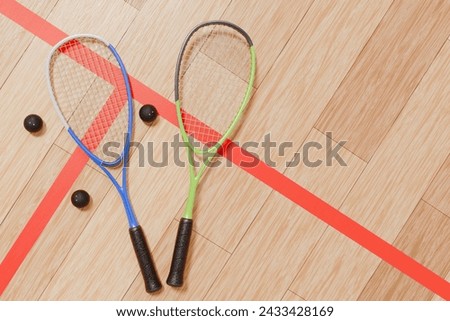 Two squash rackets and balls on the court floor. 3d rendering