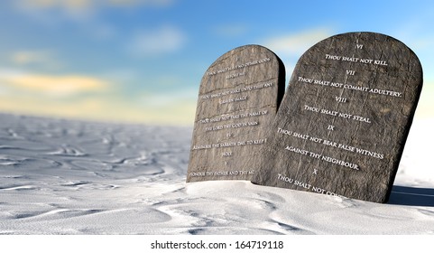 Two stone tablets with the ten commandments inscribed on them standing in brown desert sand in front of a blue sky