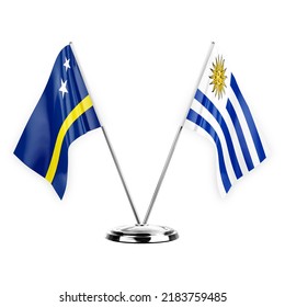 Two table flags isolated on white background 3d illustration, curacao and uruguay