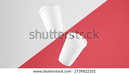 Two White coffee cups floating on diagonal Desire Red and White background. blank coffee cups mockup.