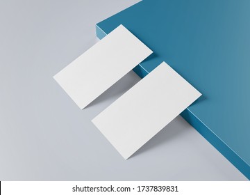 Two White US Business Card Mockup Laying On Blue And Grey Background. American Size Calling Card Front And Back Laying On Colored Surface 3D Rendering